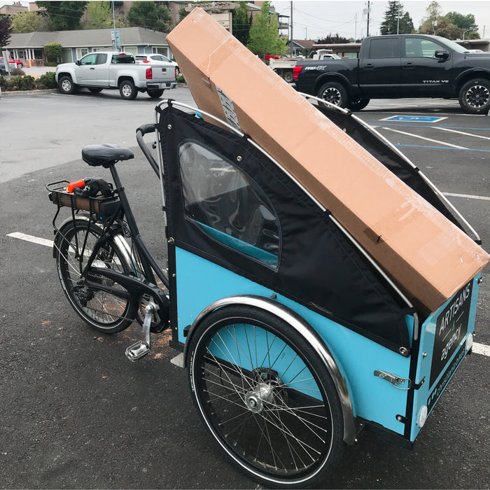 Blue Cargo bike transporting furniture