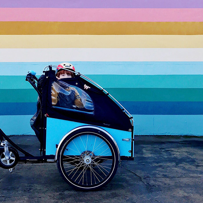 Christiania Bike against a rainbow wall