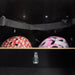 Interior view of the cargo box in the Classic Sloped midDrive Pro I5 by Christiania Bikes America, featuring space for two helmets with a safety strap.